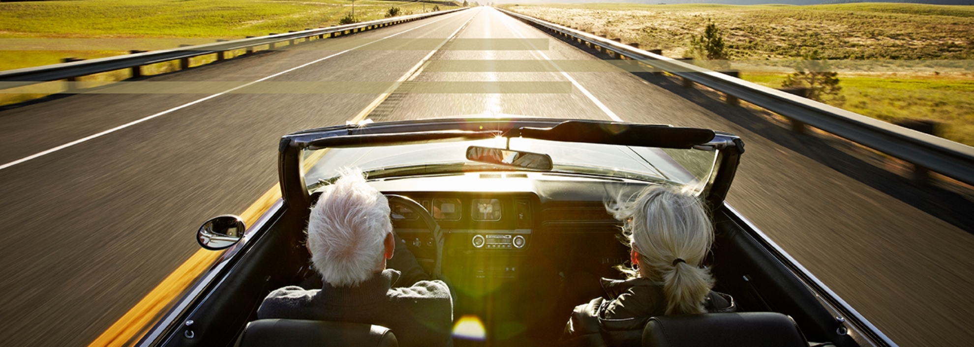 Mature couple driving in convertible